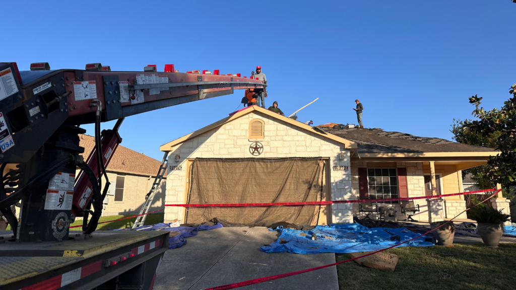 Home protection during roof replacement in San Antonio showing professional roofers protecting landscaping, windows, siding, gutters, and the surrounding property during a residential roof tear-off.